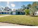 Single-story house with green exterior and spacious front yard at 1323 Karen Dr, Venice, FL 34285