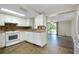 Kitchen with white cabinets, tiled floors, and view to living room at 1323 Karen Dr, Venice, FL 34285