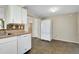 White appliances and cabinets in this galley-style kitchen at 1323 Karen Dr, Venice, FL 34285