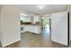 Kitchen with white cabinets, tiled floors, and view to living room at 1323 Karen Dr, Venice, FL 34285