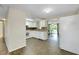 Kitchen with white cabinets, tiled floors, and view to living room at 1323 Karen Dr, Venice, FL 34285