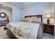 Bright bedroom with a queen-size bed and a nightstand at 19764 Ortona St, Venice, FL 34293