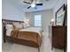 Bedroom with king-size bed, dark wood furniture and ceiling fan at 19764 Ortona St, Venice, FL 34293