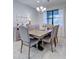 Bright dining room featuring a wood table and six gray cushioned chairs at 19764 Ortona St, Venice, FL 34293