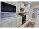 Modern kitchen with granite countertops, stainless steel appliances, and white cabinets at 19764 Ortona St, Venice, FL 34293