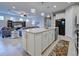 Kitchen island with granite countertop and white cabinets, open to living room at 19764 Ortona St, Venice, FL 34293