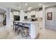 Modern kitchen with white cabinets, granite countertops, and an island at 19764 Ortona St, Venice, FL 34293