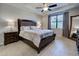 Main bedroom with wood furniture, ceiling fan and large mirror at 19764 Ortona St, Venice, FL 34293