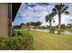 Waterfront property with a scenic view of a canal, lush landscaping, and palm trees at 19764 Ortona St, Venice, FL 34293