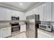 Modern kitchen featuring stainless steel appliances and granite countertops at 20428 Lagente Cir, Venice, FL 34293