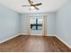 Bedroom with hardwood floors, ceiling fan and large window at 21621 Winter Park Ct, Venice, FL 34293