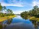 Picturesque canal view with lush landscaping at 21621 Winter Park Ct, Venice, FL 34293