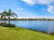 Stunning lakefront view with lush landscaping and neighborhood homes at 21621 Winter Park Ct, Venice, FL 34293