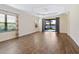 Spacious living room featuring hardwood floors and sliding glass doors leading to a lanai at 21621 Winter Park Ct, Venice, FL 34293