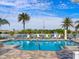 Community pool with lounge chairs and a beautiful view at 21621 Winter Park Ct, Venice, FL 34293