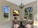 Cozy breakfast nook with round table and view of backyard at 2331 Harrier Way, Nokomis, FL 34275