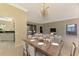 Elegant dining room with a large wooden table and chandelier at 2331 Harrier Way, Nokomis, FL 34275