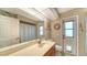 Bathroom with double vanity, shower, and private access at 23442 Moreland Ave, Port Charlotte, FL 33954