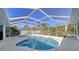 Inviting screened pool with a swim-up bar at 23442 Moreland Ave, Port Charlotte, FL 33954