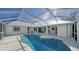 Relaxing kidney-shaped pool with screened enclosure and patio access at 23442 Moreland Ave, Port Charlotte, FL 33954