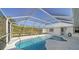 Inviting kidney-shaped pool with screened enclosure at 23442 Moreland Ave, Port Charlotte, FL 33954