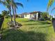 Large backyard with screened patio and lush grass at 2501 Sherman Oak Dr, North Port, FL 34289