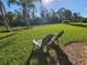 Spacious backyard with lush grass and two chairs at 2501 Sherman Oak Dr, North Port, FL 34289