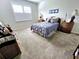 Spacious bedroom with carpeted floor and wicker furniture at 2501 Sherman Oak Dr, North Port, FL 34289