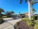 Community patio with tables, umbrellas, and grill at 2501 Sherman Oak Dr, North Port, FL 34289