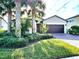 Single-story home with a two-car garage and lush landscaping at 2501 Sherman Oak Dr, North Port, FL 34289