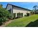 Rear view of house showcasing garage and landscaping at 2501 Sherman Oak Dr, North Port, FL 34289