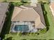 Aerial view showcasing a home with a screened pool at 614 May Apple Way, Venice, FL 34293