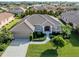 Single-story home with tile roof and driveway at 614 May Apple Way, Venice, FL 34293