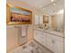 Elegant bathroom with double vanity and large mirror at 614 May Apple Way, Venice, FL 34293