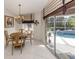 Bright breakfast nook with table and chairs, adjacent to pool at 614 May Apple Way, Venice, FL 34293