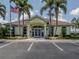 Community center with palm trees and ample parking at 614 May Apple Way, Venice, FL 34293