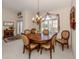 Elegant dining room with large table and chandelier at 614 May Apple Way, Venice, FL 34293