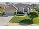 One-story home with tile roof, double doors, and landscaped yard at 614 May Apple Way, Venice, FL 34293