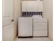 Bright laundry room with washer, dryer, and cabinets at 614 May Apple Way, Venice, FL 34293