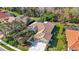 An aerial view showcases a landscaped home with a red tile roof at 6930 Treymore Ct, Sarasota, FL 34243