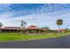 Exterior of the community clubhouse with well-maintained lawns and elegant landscaping at 6930 Treymore Ct, Sarasota, FL 34243