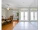 Formal dining room featuring wood floors, crown molding, a modern ceiling fan, and views of the front entrance at 6930 Treymore Ct, Sarasota, FL 34243