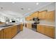 Bright kitchen with stainless steel appliances, light wood cabinets, and ample counter space at 6930 Treymore Ct, Sarasota, FL 34243