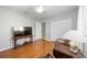 Comfortable living room featuring hardwood floors, neutral walls, and a ceiling fan at 6930 Treymore Ct, Sarasota, FL 34243