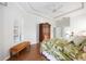 Main bedroom featuring hardwood floors, ceiling fan, shuttered windows and access to the ensuite at 6930 Treymore Ct, Sarasota, FL 34243