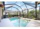 Inviting pool with a screen enclosure and well-maintained landscaping around the yard at 6930 Treymore Ct, Sarasota, FL 34243