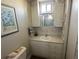 Small bathroom features a seashell decor, a large mirror, and an accent backsplash at 789 N Green Cir, Venice, FL 34285