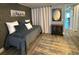 Bedroom featuring dark textured wallpaper and a daybed with a decorative mirror at 789 N Green Cir, Venice, FL 34285