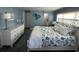 Bright bedroom featuring stylish coastal decor, furniture, a bed, and a large window at 789 N Green Cir, Venice, FL 34285