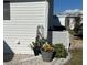 Home exterior featuring white siding, gravel landscaping, and potted plants adding charm at 789 N Green Cir, Venice, FL 34285